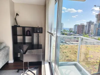 a room with a desk and a large window at Central Lonsdale Gem in North Vancouver