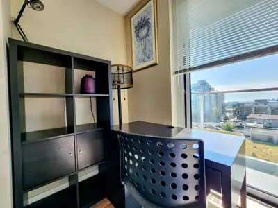 a dining room with a table and a large window at Central Lonsdale Gem in North Vancouver