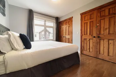 a bedroom with a large bed and a window at Rocky Mountain Retreat-Mountain View! in Canmore