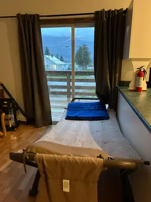 a bed in a room with a large window at 3 Bedroom Townhouse in McBride