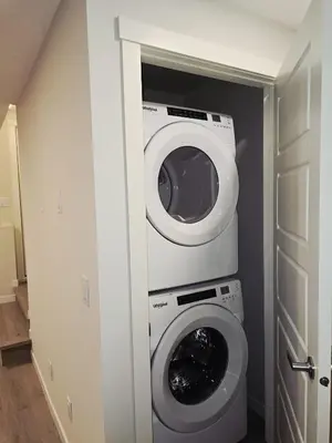 a laundry room with a washer and dryer in it at Livingston Calgary Lovely space in Calgary