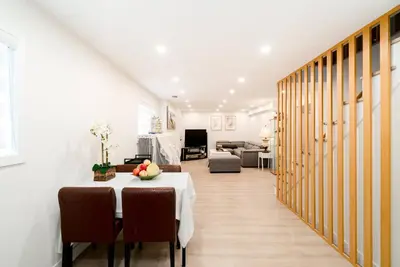 a dining room with a table and a living room at Modern Private 2 BR with 1 bath, 3 beds, West Van in West Vancouver