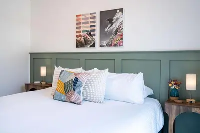 a bedroom with a white bed with two pillows at Wooley Terrace by Revelstoke Vacations in Revelstoke