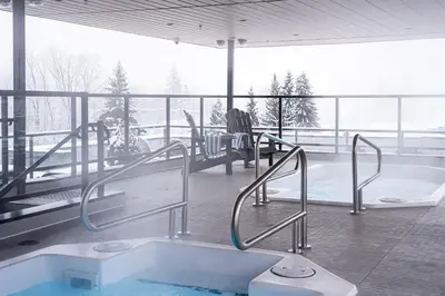 a bath tub in a room with a view of a balcony at Wooley Terrace by Revelstoke Vacations in Revelstoke