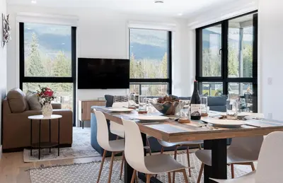 a dining room with a large table and chairs at Wooley Terrace by Revelstoke Vacations in Revelstoke