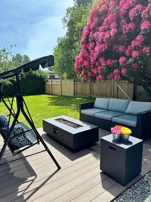 a patio with a blue couch and a swing at 2BD cozy guest suite in West Vancouver! in West Vancouver