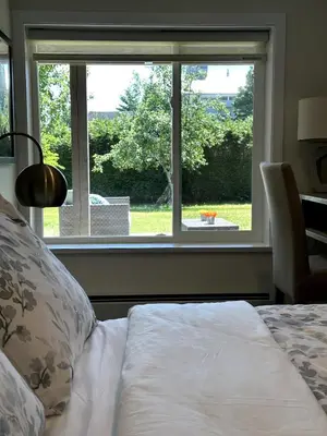 a bedroom with a bed and a large window at 2BD cozy guest suite in West Vancouver! in West Vancouver