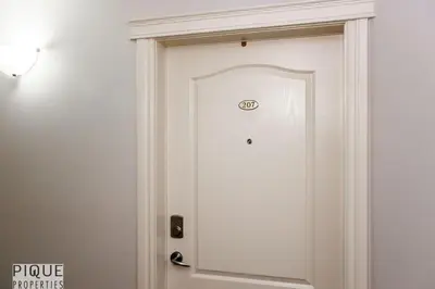 a white door with a sign on it at The Breakfast Club Suite - KingBed& AC - Patio - UG Park in Edmonton