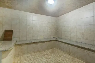 a bathroom with a tub and a tiled floor at Silver Creek 2BR Bliss Hot Tub Access MTN Views in Canmore