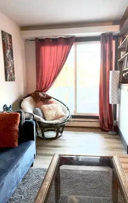 a living room with a couch and a window at Cozy boho downtown apartment in Calgary
