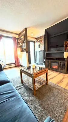 a living room with a couch and a coffee table at Cozy boho downtown apartment in Calgary