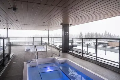 a hot tub on the deck of a building at Bluebird by Revelstoke Vacations in Revelstoke