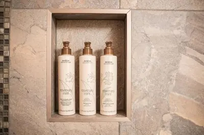 three bottles sitting on a shelf in a wall at Wildwood Lodge 113 by Outpost Whistler in Whistler