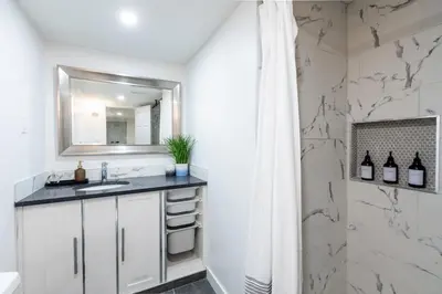 a bathroom with a sink and a mirror at Cozy Quiet Suite - 2 Bedrooms and 2 Full Bathrooms in Calgary