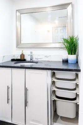 a bathroom with a sink and a mirror at Cozy Quiet Suite - 2 Bedrooms and 2 Full Bathrooms in Calgary