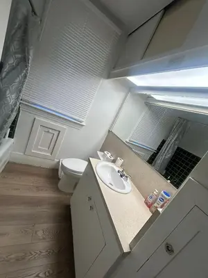 a bathroom with a sink and a toilet at Vancouver Budget Guesthouse - Free Parking, Fast WiFi, Near Airport & Downtown in Vancouver