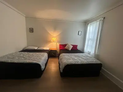 a hotel room with two beds and a window at Vancouver Budget Guesthouse - Free Parking, Fast WiFi, Near Airport & Downtown in Vancouver