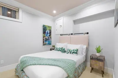 a white bedroom with a bed and a table at NEW Private 1BR Near Kerrisdale and UBC w Laundry in Vancouver