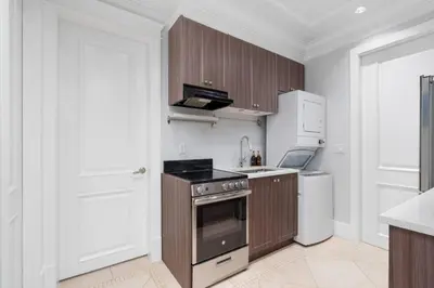 a kitchen with a stove and a white refrigerator at NEW Private 1BR Near Kerrisdale and UBC w Laundry in Vancouver