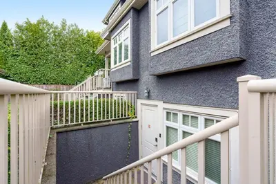 a house with a white fence and a gate at NEW Private 1BR Near Kerrisdale and UBC w Laundry in Vancouver