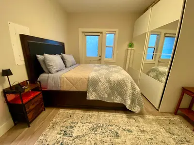 a bedroom with a bed and a large mirror at Ridge Pointe Retreat Your Victoria Hideaway in Colwood