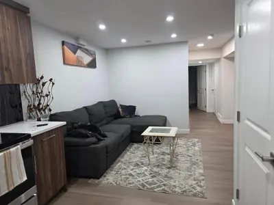 a living room with a couch and a table at YYC Cozy Suites in Calgary