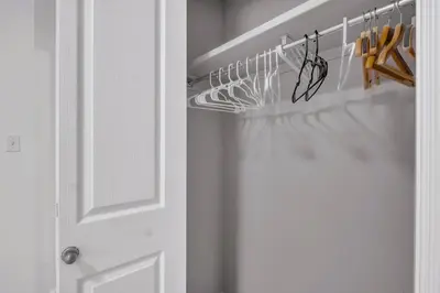 a closet with a white door and some hangers at Home Theater•Luxury•Entire4BHome•GamesRoom•KingBed in Edmonton