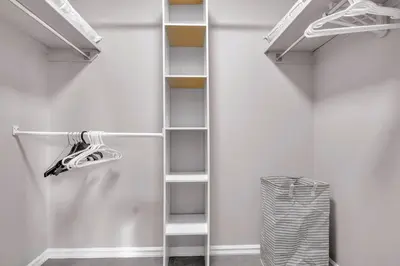 a walk in closet with white shelving at Home Theater•Luxury•Entire4BHome•GamesRoom•KingBed in Edmonton