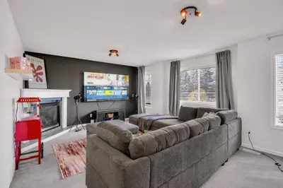 a living room with a couch and a tv at Home Theater•Luxury•Entire4BHome•GamesRoom•KingBed in Edmonton