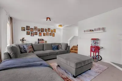 a living room with a gray couch and a stool at Home Theater•Luxury•Entire4BHome•GamesRoom•KingBed in Edmonton