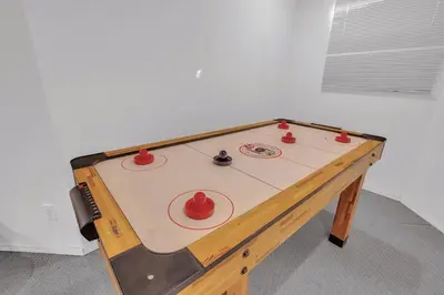 a ping pong table with three balls on it at Home Theater•Luxury•Entire4BHome•GamesRoom•KingBed in Edmonton