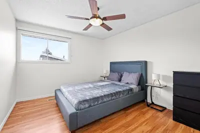 a bedroom with a bed and a ceiling fan at Quiet & Modern Calgary Stay, Prime Location Near YYC, Free Parking in Calgary
