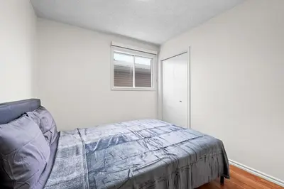 a bedroom with a bed and a window at Quiet & Modern Calgary Stay, Prime Location Near YYC, Free Parking in Calgary