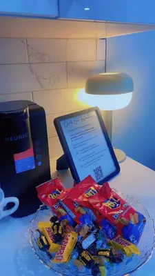 a table with a plate of candy bars and a tablet at Brand New cozy apartment bright, modern private 2 bedroom basement! in Calgary