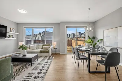 a living room with a table and a couch at Herron Rise Luxury 4 Bedroom Main Floor in Calgary