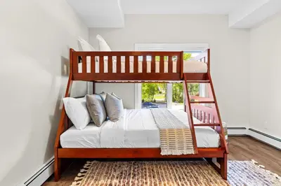 a bedroom with a bunk bed with a ladder at Tranquil 2BR Golden Oasis BBQ, Balcony, MTN Views in Golden