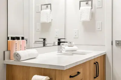 a bathroom with a sink and a mirror at Brand New 2BR Oasis Mins to DT with AC Balcony and BBQ in Golden