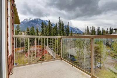 a balcony with a view of a mountain at Cozy 2 BR Condo plus Gym with Stunning Mountain View in Canmore
