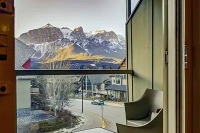 a view of a mountain view from a window at Charming 2BR Condo with Spectacular Mountain Views in Canmore