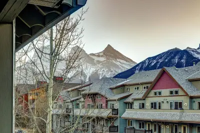 a group of houses in front of a mountain at Charming 2BR Condo with Spectacular Mountain Views in Canmore