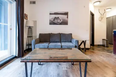 a living room with a couch and a coffee table at Renovated Haven in Rockies with Hot Tub and Pool in Canmore