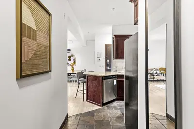 a kitchen and dining room with white walls at Splendid Mountain View 2BR Condo with Pool and Hot Tub in Canmore
