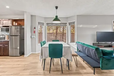 a kitchen and dining room with a table and chairs at 2BR Bow Valley Retreat with BBQ Near Parks and Banff in Canmore