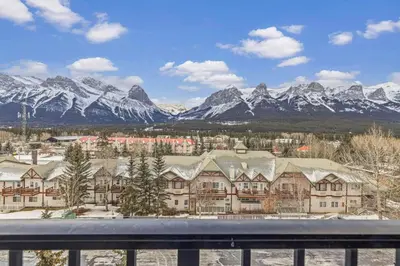 a view of a resort with snow covered mountains at Relaxing 1BR Getaway Hot tub plus Amazing Mtn Views in Canmore