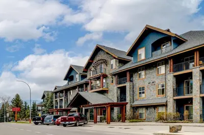 a large building with cars parked in front of it at Cozy Rocky Mountain Studio with Hot tub and Gym in Canmore