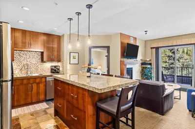 a kitchen with a large island in the middle at Ideal 2BR Canmore Haven Hot Tub plus Stunning Views in Canmore