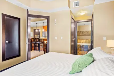 a bedroom with a bed and a dining room at Ideal 2BR Canmore Haven Hot Tub plus Stunning Views in Canmore