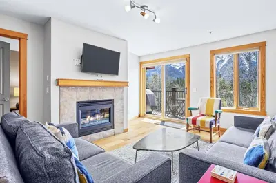 a living room with a couch and a fireplace at Peaceful 2BR Retreat with MTN Views Close to Banff in Canmore