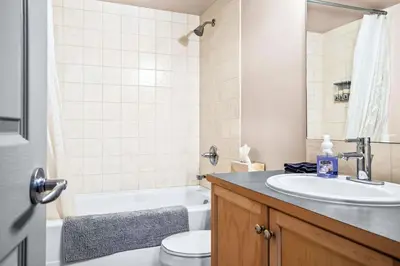 a bathroom with a sink and a toilet and a tub at Peaceful 2BR Retreat with MTN Views Close to Banff in Canmore