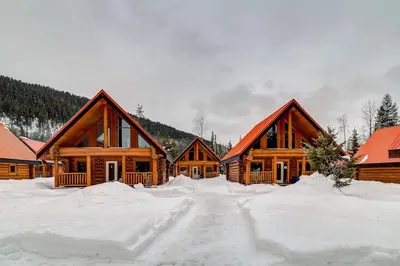 a row of wooden homes in the snow at Beautiful Rustic Chalet in the Heart of Rockies in Golden